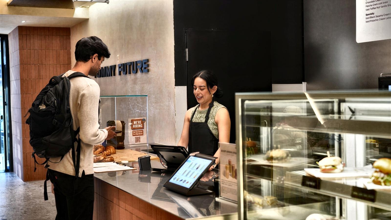 A customer ordering at the counter in a live store
