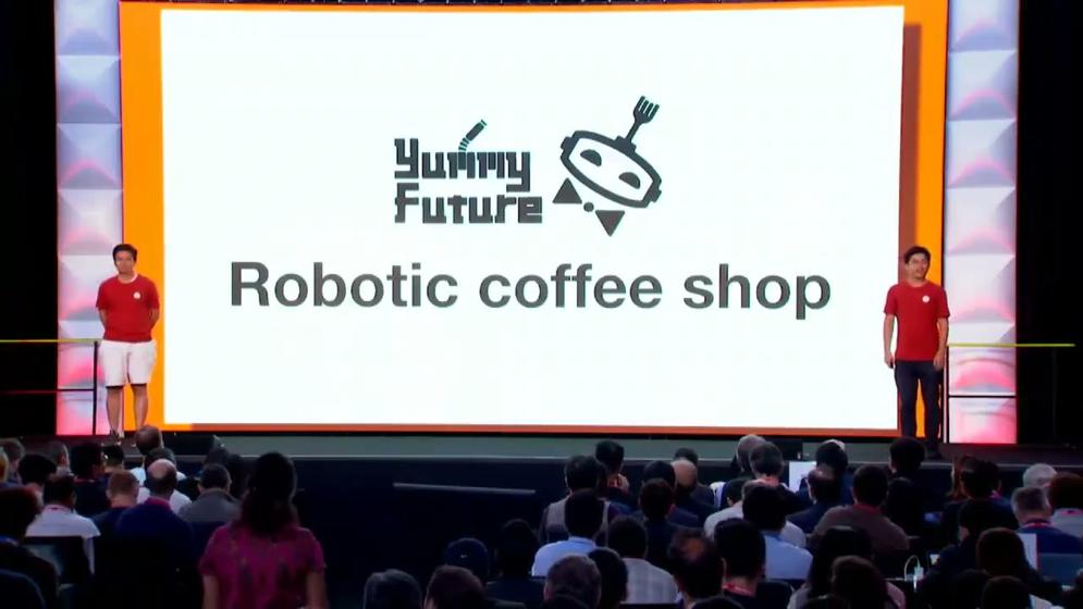 Both founders on the Y Combinator S19 Demo Day stage, screen reading Robotic coffee shop